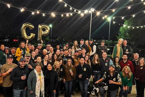 Members of the Cal Poly Alumni – Modesto Community posing for a photo at an event.