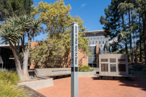 The Peace Pole on the patio outside of UU Plaza on the San Luis Obispo Campus.