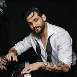 Richard Cortez sitting at a piano.