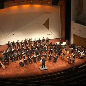 The Cal Poly Winds Band performing on stage.