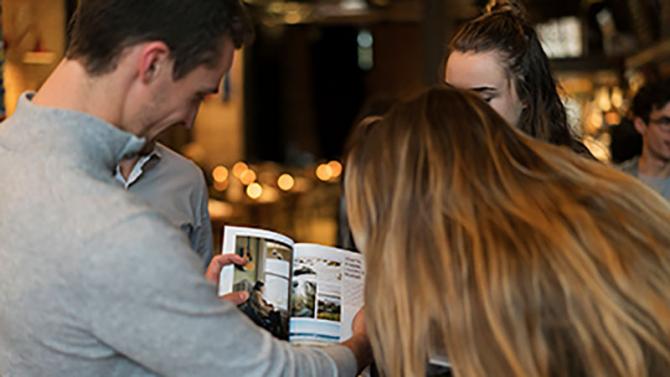 Art and Design students viewing copy of .RAW Magazine