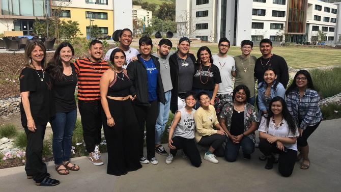 A group of students, staff and faculty pose. 