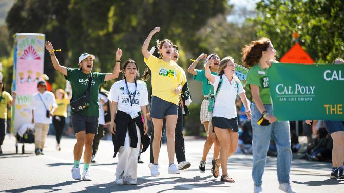 Students cheer while walking in a parade during the annual Open House