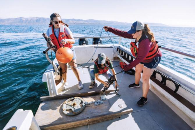 Students prepare to deploy a listening device into local ocean waters