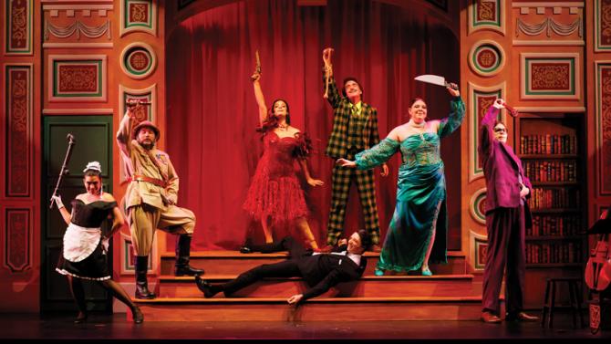 Seven actors strike a dramatic pose on stage during "Clue: The Musical" at Cal Poly