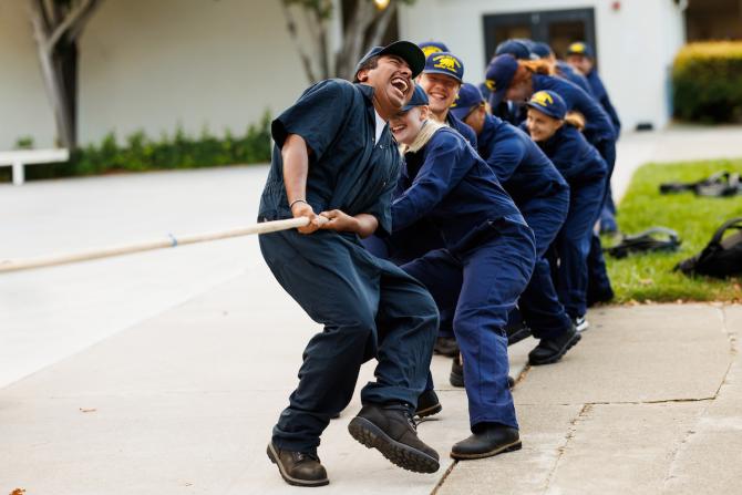 Maritime students enjoy a game of tug of war.