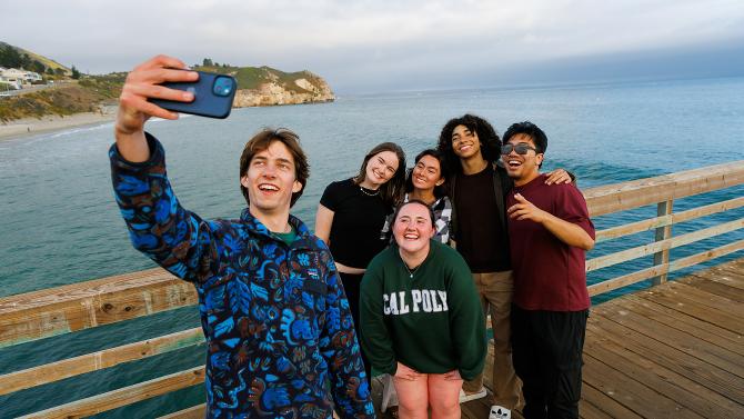 Several students pose for a selfie on the Avila Pier.